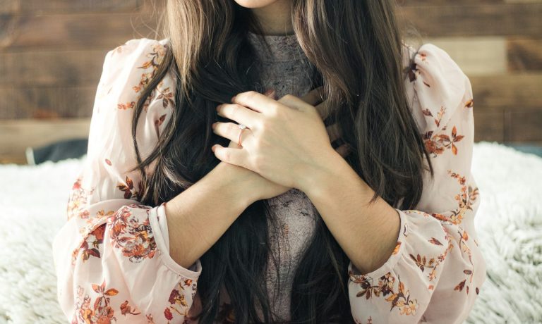 woman in white and red floral long sleeve shirt
